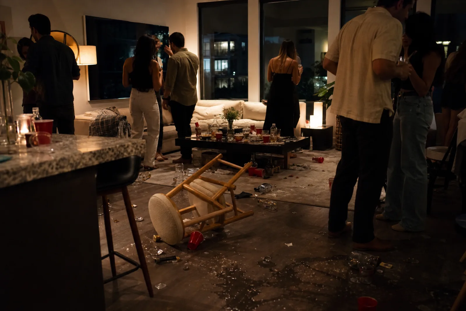 Rowdy adult party leaving a short-term rental cluttered with spills and tipped furniture